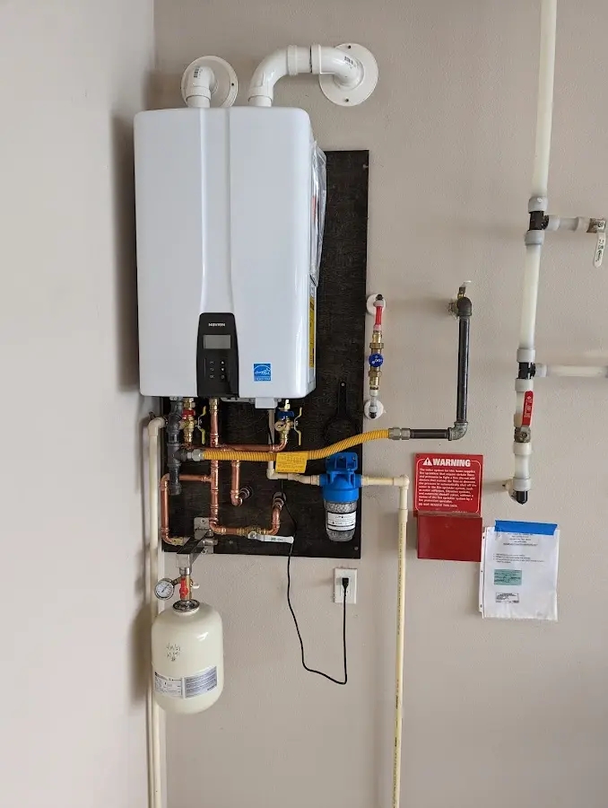 Professional plumber installing copper piping in a Macedonia home